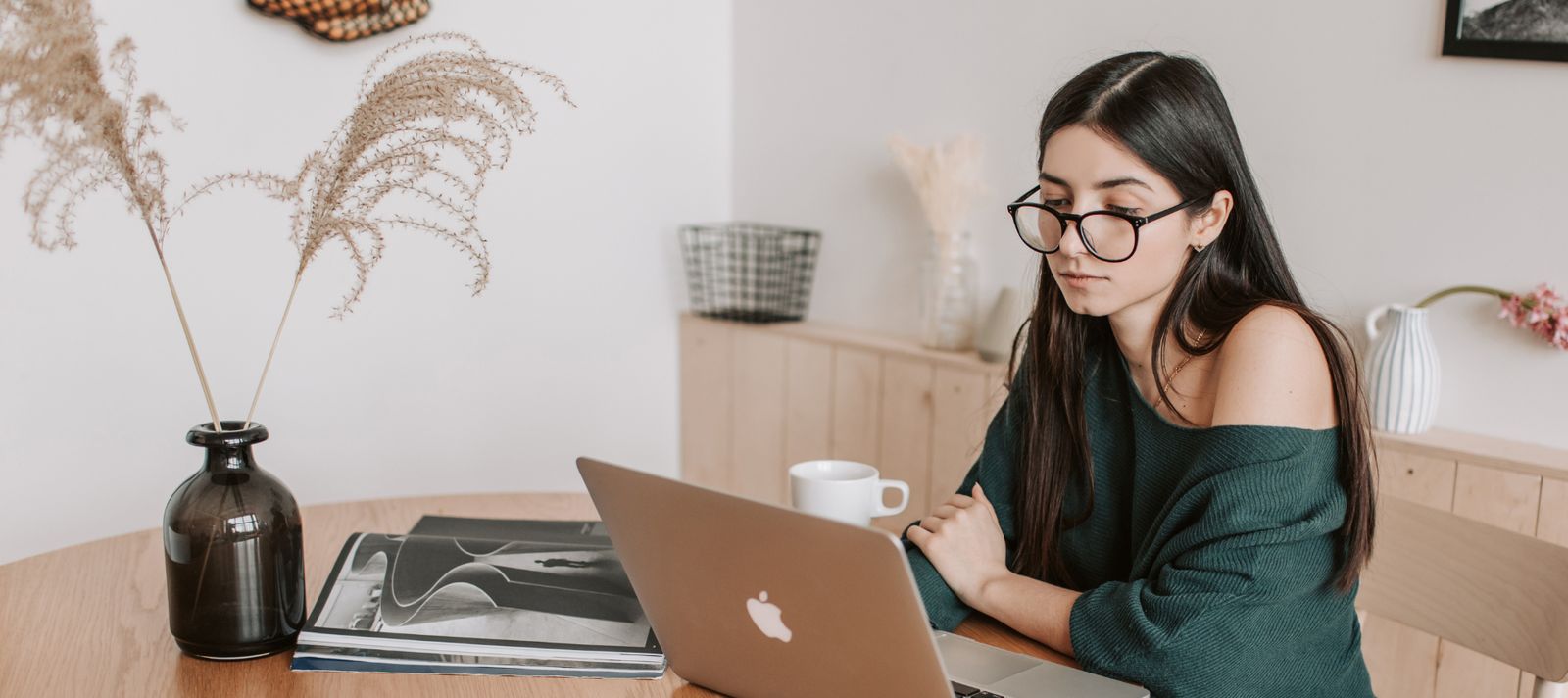 Woman reviewing her finances on a laptop at home