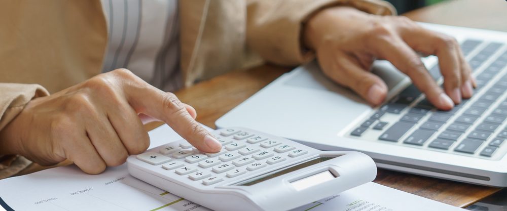 Laptop and calculator on a desk